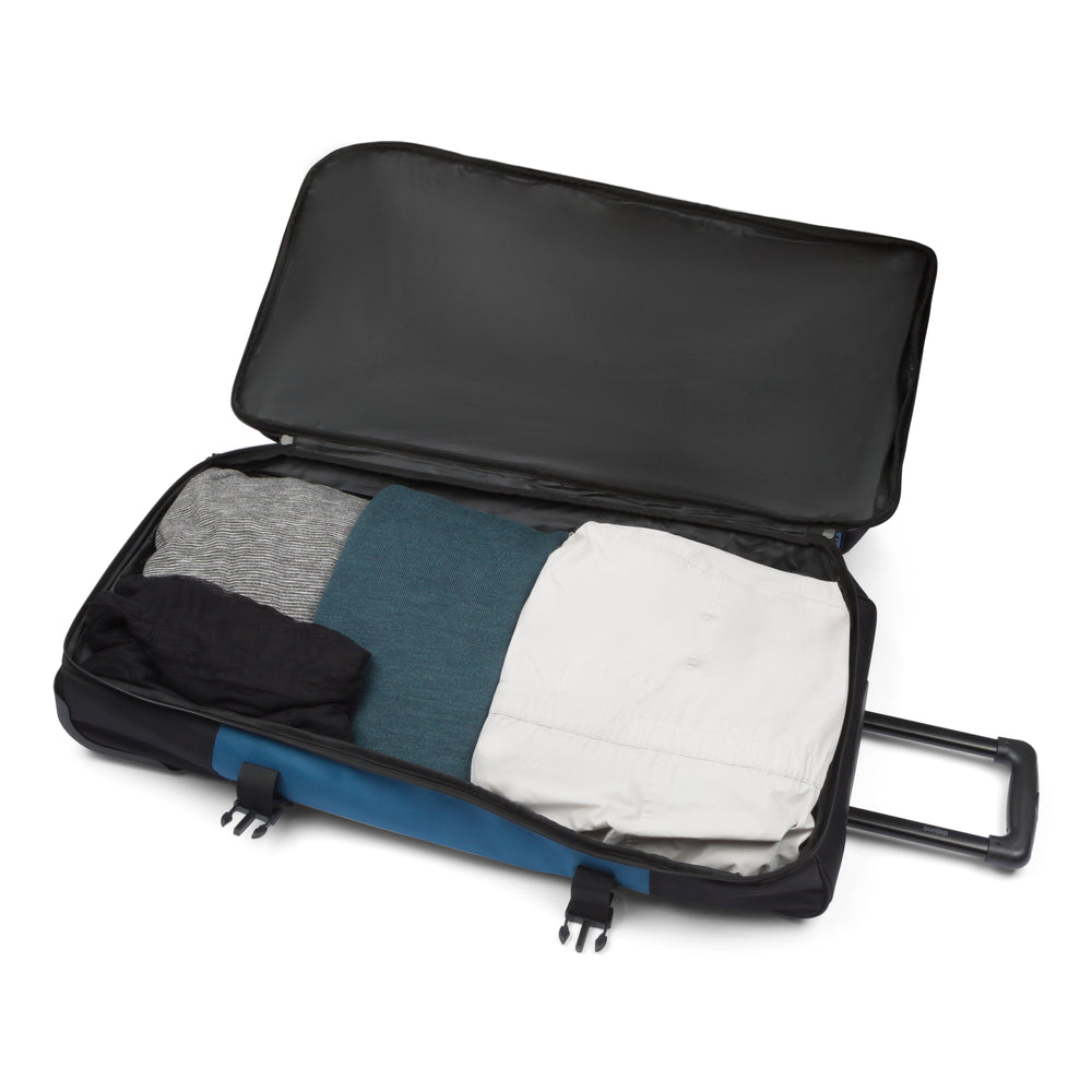 Excursion rolling duffel bag in Black Navy, drop-bottom compartment open