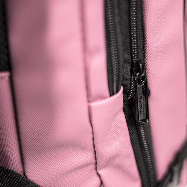 Close-up of the Stryde backpack zipper and durable Mauve PU fabric